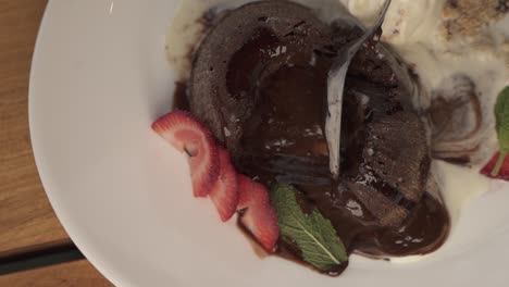 Close-up-of-spoon-in-chocolate-volcano-lava-dessert