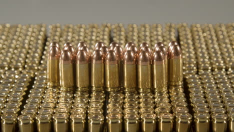 Dolly-out-of-bullets-standing-on-boxes-of-ammunition-against-a-white-background
