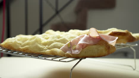 The-Chef-is-placing-delicious-Italian-Mortadella-on-top-of-a-crusty-and-airy-pizza-sandwich