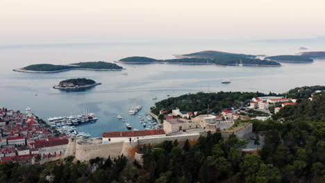 Aerial-View-Of-The-Famous-Hvar-Island-And-Old-Town-With-Its-Luxury-Yachts-Harbor-In-Croatia---drone-shot
