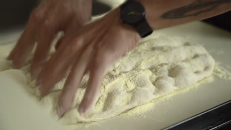 Pizzaiolo-hand-stretching-roman-high-hydration-pizza-dough