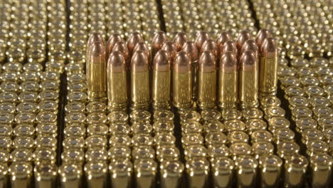 Dolly-towards-9-millimeter-bullets-standing-on-loads-of-new-ammunition