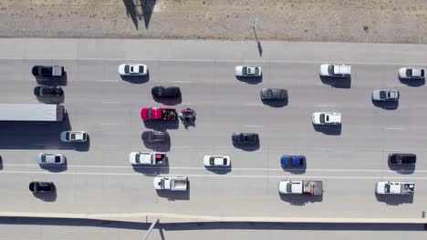 Top-Down-Aerial-View-of-Cars-Moving-Slowly-on-a-Highway-on-a-Bright-Sunny-Day