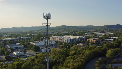 Aerial-view-passing-by-5G-cell-phone-radio-communications-tower,-4K