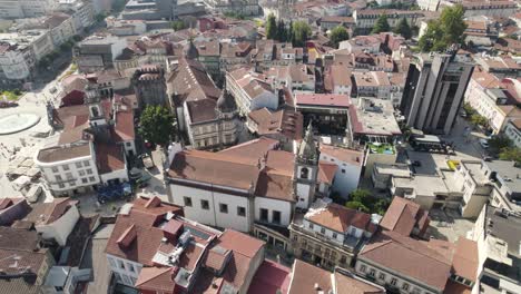 Drone-top-down-over-Braga-city-centre-houses-with-church-and-Squares---Portugal