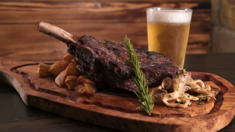 Mouthwatering-bone-in-strip-steak,-roasted-potatoes,-wild-woodear-mushrooms-and-rosemary-elegantly-arranged-on-a-wooden-carving-board-with-a-frosty-beer,-slider-HD