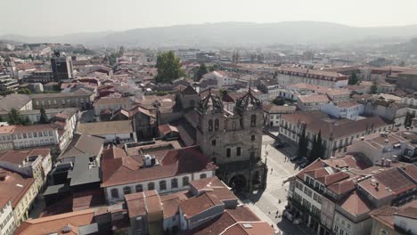 Aerial-backwards-view-of-the-Romanic-cathedral-in-the-historic-center-of-Braga
