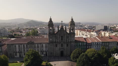 Aerial-rotation-over-Old-Congregados-Minster-Building,-Braga-old-town---Portugal