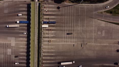 Aerial-top-down-shot-of-trucks-arriving-toll-after-driving-on-highway-in-Buenos-Aires---Payment-of-toll-fee-in-Argentina
