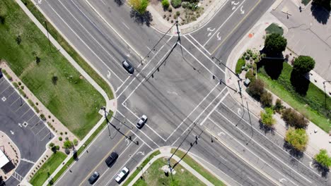 Aerial-top-down-circling-and-rising-above-crossroad-with-car-traffic