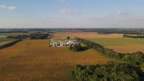Aerial-video-of-drone-flying-towards-a-farm-and-feed-factory-in-the-countryside