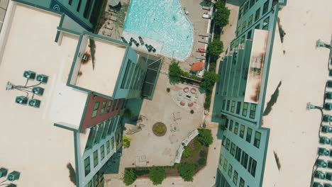 Drone-footage-offering-an-overhead-view-of-an-apartment-complex-with-a-pool-and-patio-area