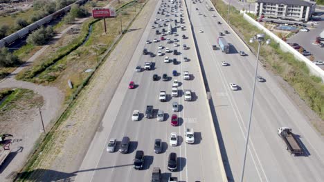Aerial-Tilt-Up-Shot-Revealing-Cars-Driving-in-Traffic-on-Highway-Interstate-in-Utah