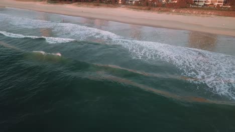 Drone-aerial-over-ocean-waves-in-Gold-Coast-during-sunrise