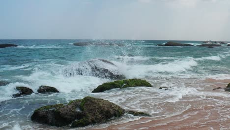 Sea-waves-crashing-on-a-rock,-on-the-coast-of-Yala,-Sri-Lanka