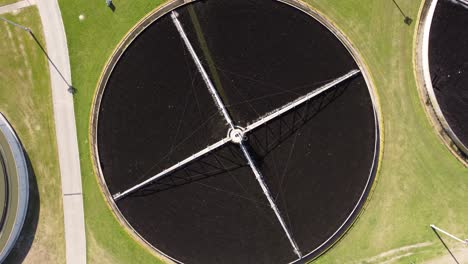 Descending-Top-down-view-of-AySa-water-purification-plant-located-in-Buenos-Aires-containing-circular-pool-where-water-is-stored-for-purification-purpose