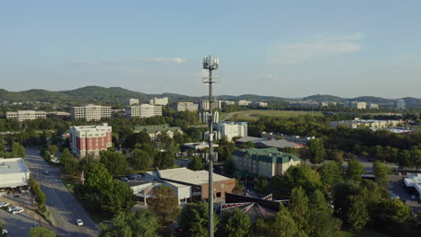 4K-aerial-of-5G-cell-phone-radio-communication-tower-in-busy-suburban-area