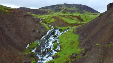 Flying-over-the-magical-white-river-flowing-through-Reykjadalur-Valley,-Iceland