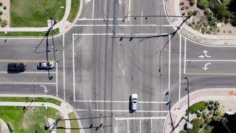 Top-Down-Aerial-View-Of-Intersection-With-Cars-Passing-Through