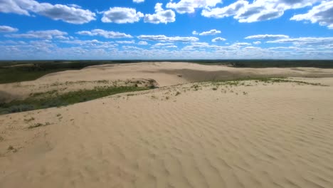 Desert-sand-dune-in-Alberta-Canada-on-a-sunny-day-with-some-clouds-in-the-sky