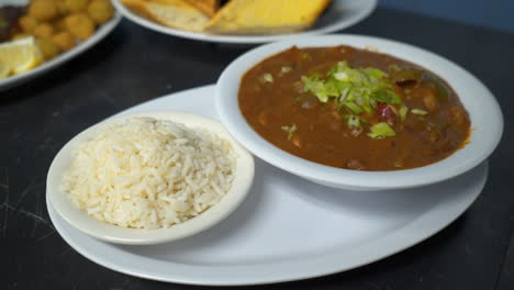 Restaurant-plating-of-traditional-Cajun-Gumbo-and-white-rice,-slider-HD