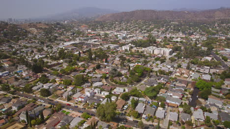 Pull-back-over-homes-and-streets-of-Eagle-Rock-neighborhood-in-Los-Angeles,-California-on-a-beautiful-day