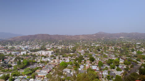 Aerial-boom-up-over-Eagle-Rock-neighborhood-in-Los-Angeles,-California-on-a-beautiful-and-clear-blue-sky-summer-day