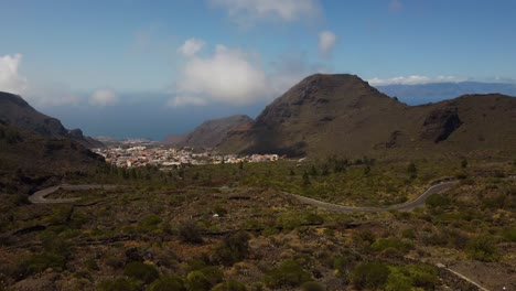 Nice-Scenery-Of-City-Buildings-Road-Between-Mountain-Spain-Tenerife-Drone-Shot-4K-Island