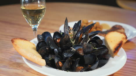 A-plate-of-steamed-mussels-and-a-glass-of-white-wine,-slider-HD