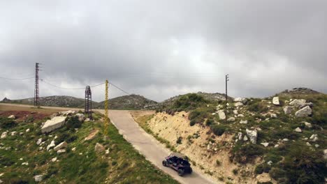 Off-road-Vehicle-Driving-At-The-Road-Amidst-The-Rugged-Landscape-On-A-Cloudy-Sky-In-Lebanon