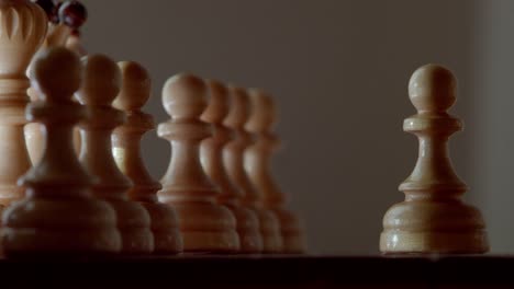 The-hand-takes-a-pawn-and-starts-a-chess-game-with-the-first-move