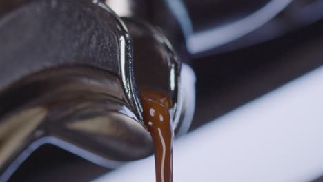 Close-up-of-coffee-maker-pouring-freshly-brewed-quality-coffee-in-the-morning