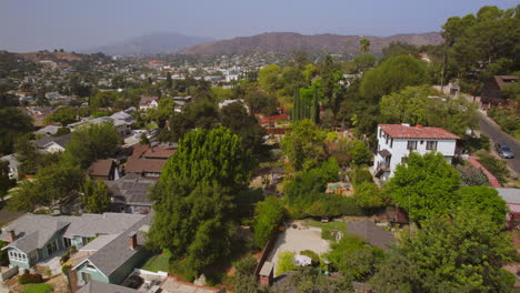 Push-over-houses-and-trees-in-beautiful-Eagle-Rock-neighborhood-in-Los-Angeles,-California-on-a-pretty-summer-day