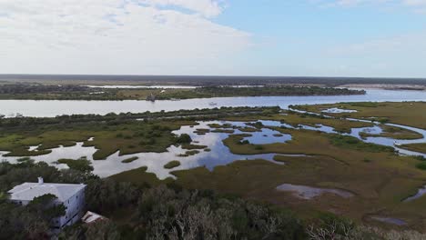 Reverse-shot-flying-over-some-marshland-by-the-Matanzas-river,-USA