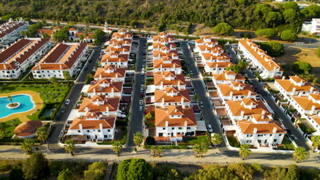 Aerial-View-Of-Modern-Tract-Housing-With-Outdoor-Pool-On-A-Sunny-Day-In-El-Rompido,-Spain