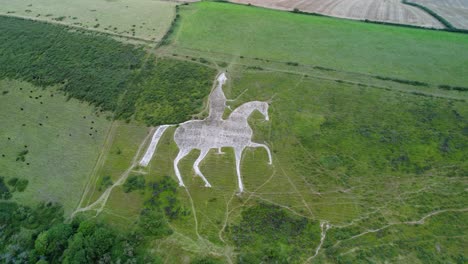 Osmington-White-Horse-historical-chalk-figure-art-on-hillside-slope-aerial-view-orbit-right