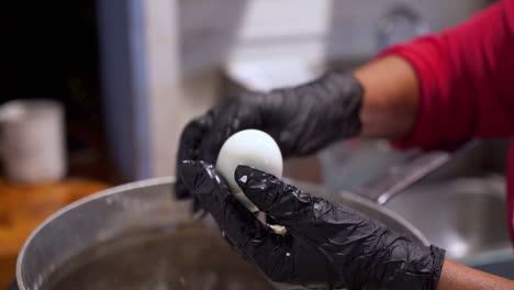 Cook-peels-shell-from-hard-boiled-egg,-slow-motion-HD