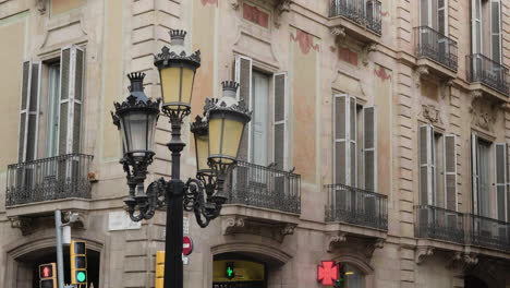 Street-Lamp-Against-Business-Building-In-The-Street-Of-La-Rambla-In-Barcelona,-Spain-At-Broad-Daylight