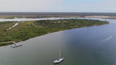 Waterscape-pedestal-shot-of-a-white-sailboat-on-Matanzas-River,-Florida