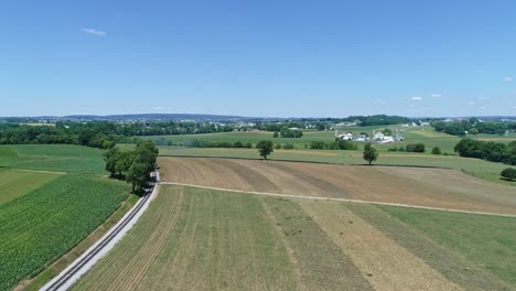 An-Aerial-View-of-the-Farm-Countryside-with-a-Single-Rail-Road-Track-on-a-Curve-on-a-Beautiful-Sunny-Day