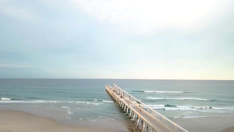 Drone-aerial-shot-over-beach-pier-in-Gold-Coast