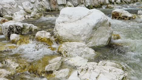 Stones-and-crystal-clear-water-in-Sava-Bohinjka-river-in-Slovenia-with-panning-motion