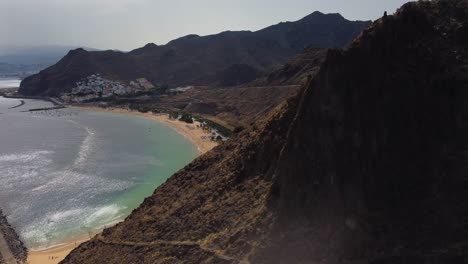 Awesome-Drone-shot-in-4K-Of-Mountains-And-Sandy-Beach-With-Amazing-Blue-Water-Seaside-Seashore-in-Spain-Tenerife-Island