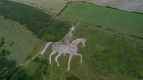 Osmington-White-Horse-limestone-hillside-sculpture-countryside-tourist-attraction-aerial-descending-view