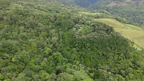 Aerial-view-moving-forward-shot,-Scenic-view-of-Trees-and-hills-of-La-Tigra-Rainforest-in-Costa-Rica,-on-a-bright-sunny-day