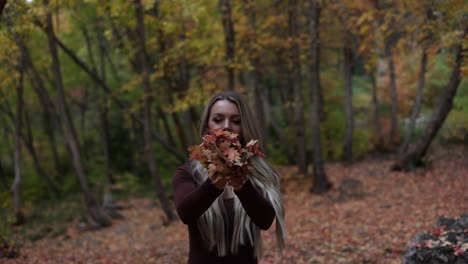 Happy-Pretty-Girl-Throws-Handfull-Of-Autumn-Leaves-In-The-Park