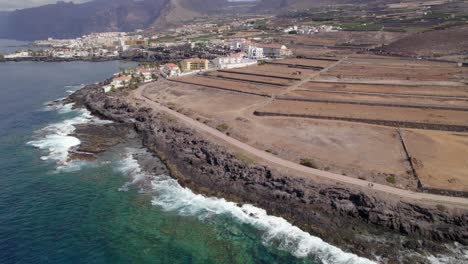Puerto-de-Santiago,-Tenerife,-Tilt-up-drone-reveal