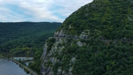 Aerial-drone-video-footage-of-an-appalachian-mountain-river-valley-with-a-beautiful-domed-mountain-with-a-road