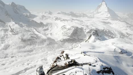 Aerial-flyover-over-Gornergrat-with-a-view-of-the-Matterhorn,-the-Gornergrat-train-station