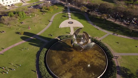 360-degree-aerial-view-of-giant-stainless-steel-and-aluminum-flower,-Floralis-Generica-in-Buenos-Aires,-Argentina